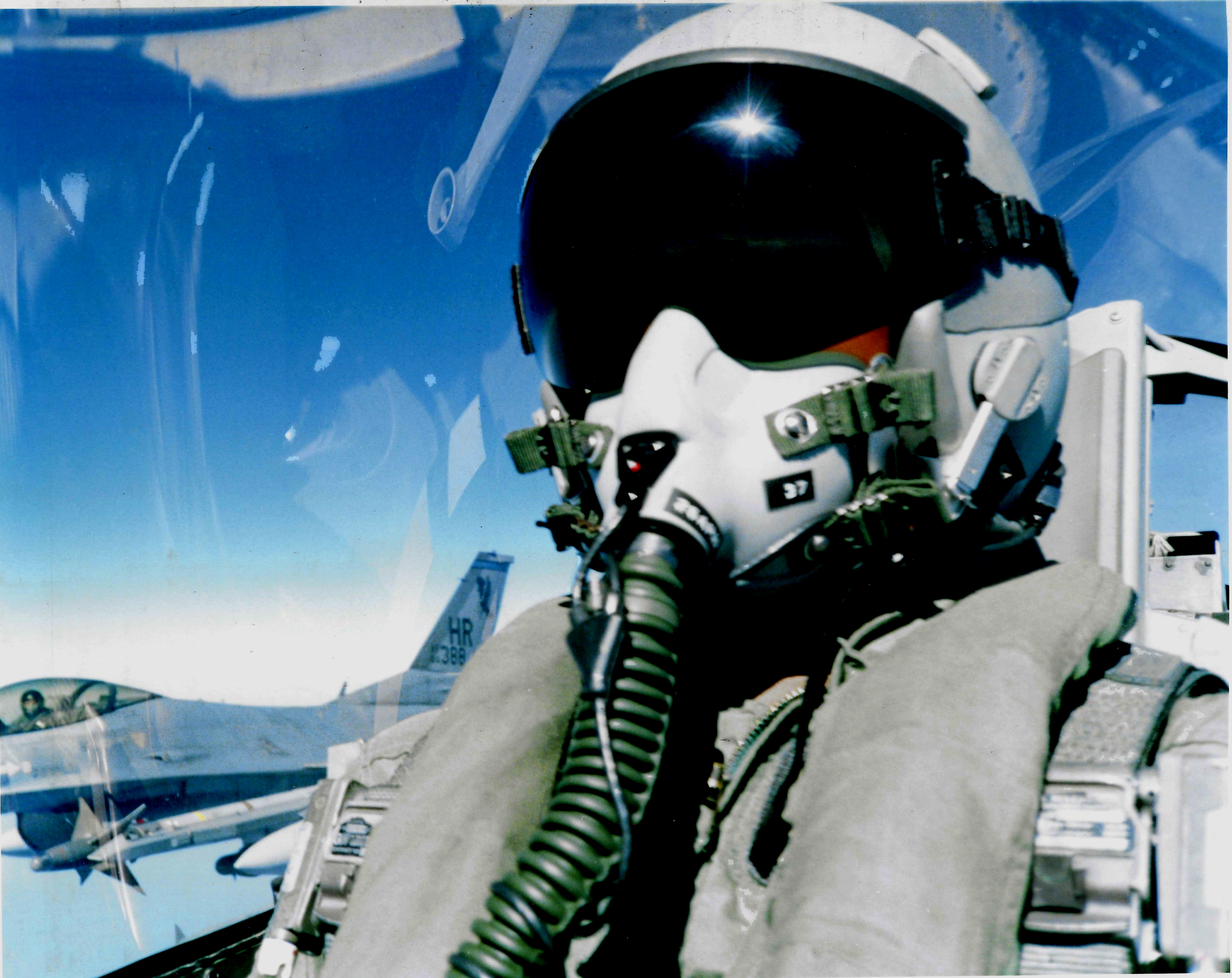 Two-ship returning to base after a deep strike — wingman framed in the canopy bow.